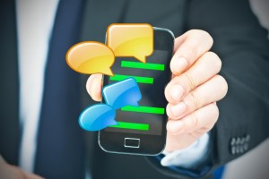 Hand holding mobile phone with chat conversation